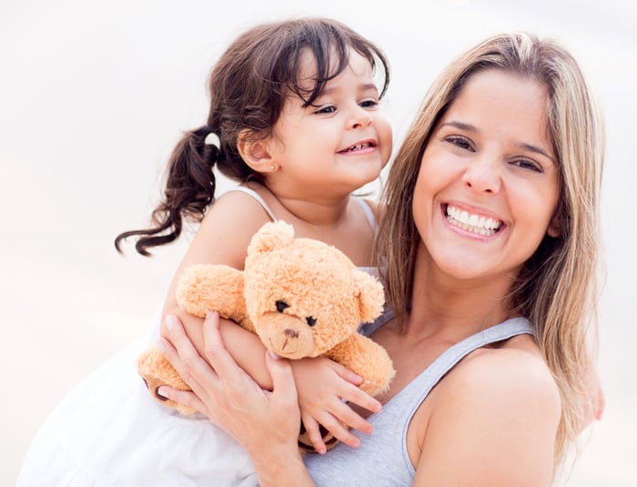 Mother and daughter portrait with a teddy bear