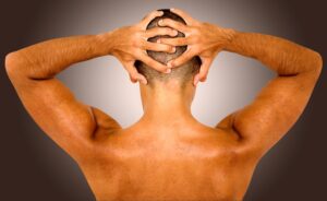muscular fit man showing his muscles on his back over a dark background 1﹖width=2058&name=muscular fit man showing his muscles on his back over a dark background 1