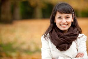 Autumn woman portrait smiling outdoors at the park