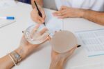 Woman discusses breast implant options with her doctor