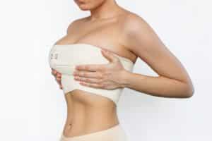 Fit young woman wearing compression garment after breast lift and reduction