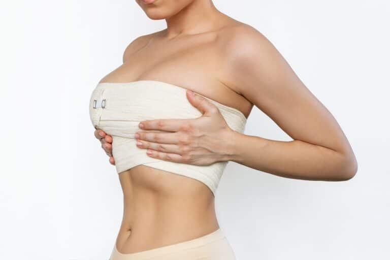 Fit young woman wearing compression garment after breast lift and reduction