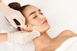 Woman closes her eyes during a dermal filler treatment
