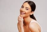 Beautiful woman in her early 30s smiles, delighted with the effects of her collagen banking treatments for skin