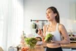 Woman eating a healthy salad after her breast augmentation