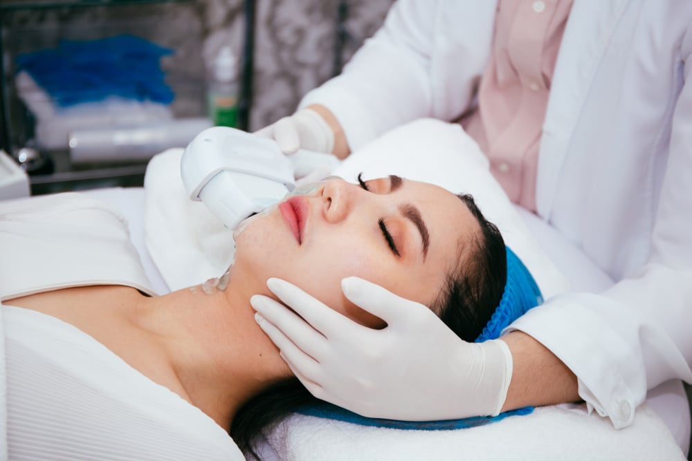 Woman relaxes during her IPL laser treatments for anti-aging