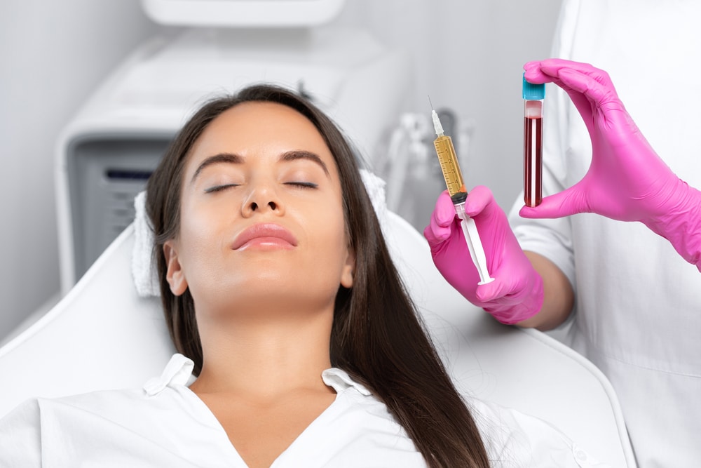 Woman, eyes shut, relaxes before her PRP facial