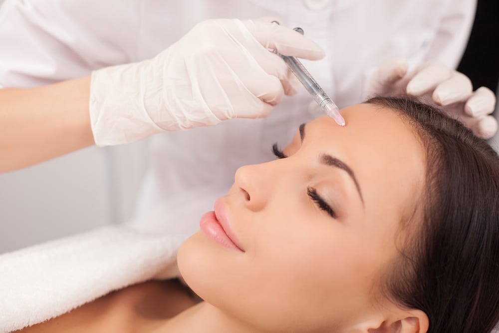 Woman gets Botox injections to smooth wrinkles
